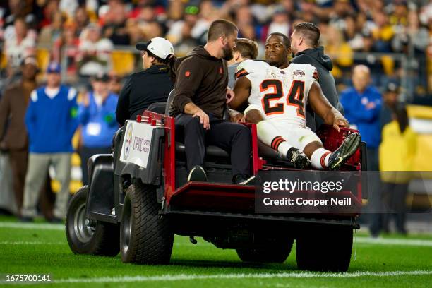 Nick Chubb of the Cleveland Browns is carted off the field against the Pittsburgh Steelers during the first half at Acrisure Stadium on September 18,...