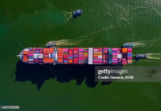 aerial top view large container ship sailing hi- speed in the green sea. - conflict stock pictures, royalty-free photos & images