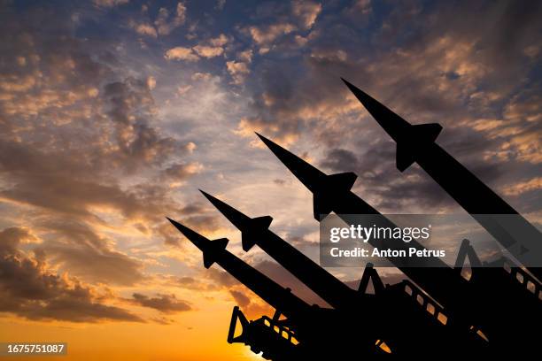 missile system on the background of sunset sky - atoombom stockfoto's en -beelden