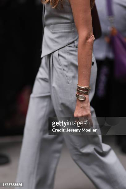 Fashion Week guest is seen wearing a grey two-piece consisting of a waistcoat and suit pants, a golden and a silver ring, the Serpenti Tubogas watch...