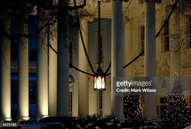 Christmas trees glow near the front entrance of the White House December 6, 2002 in Washington, DC. In a shakeup of U.S. President George W. Bush's...