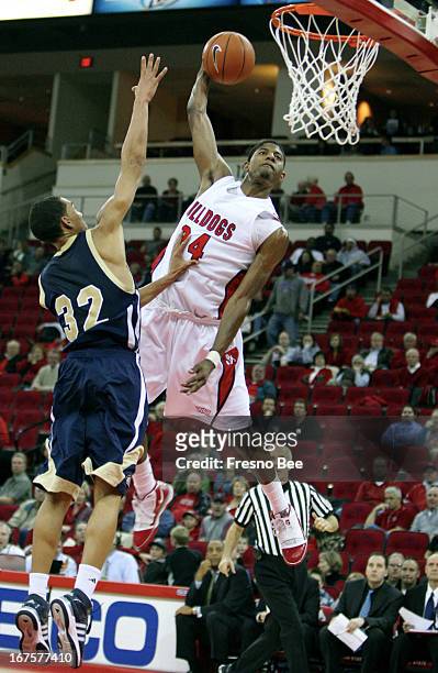Fresno State's Paul George soars to the basket for a one-handed dunk over U.C. Davis' Ryan Sypkens during the first half of their game at the Save...