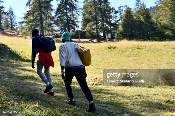 Some migrants from Sudan walk along the mountain paths that go to Briancon on September 11, 2023 in Claviere, Italy. For about a month the situation...