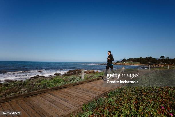 running exercise at the cambria beach, california - san luis obispo stock pictures, royalty-free photos & images