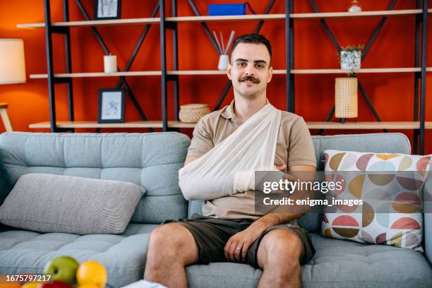 portrait of a man with a broken arm - broken arm stock pictures, royalty-free photos & images