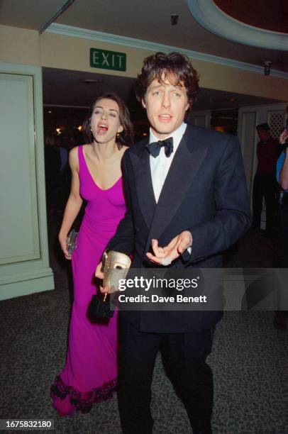 English actors Elizabeth Hurley and Hugh Grant attend the 1995 BAFTA Awards at the London Palladium, 24th April 1995.