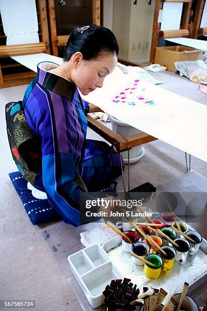 Kimono designer painting on silk. Kimono are hand made which accounts for their high cost..