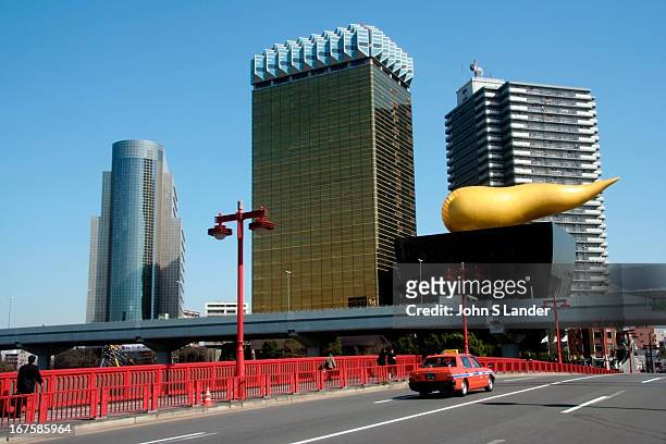 Asahi Breweries headquarters on the Sumida River in Asakusa, Tokyo. The golden structure evokes a drop of beer. The abstract sculpture that was...
