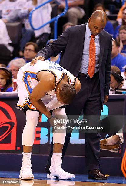 Russell Westbrook of the Oklahoma City Thunder is looked at by a trainer after a leg injury during Game Two of the Western Conference Quarterfinals...