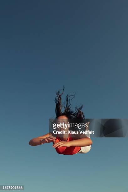 portrait of young woman flying with tousled hair - fitness or vitality or sport and women stock pictures, royalty-free photos & images