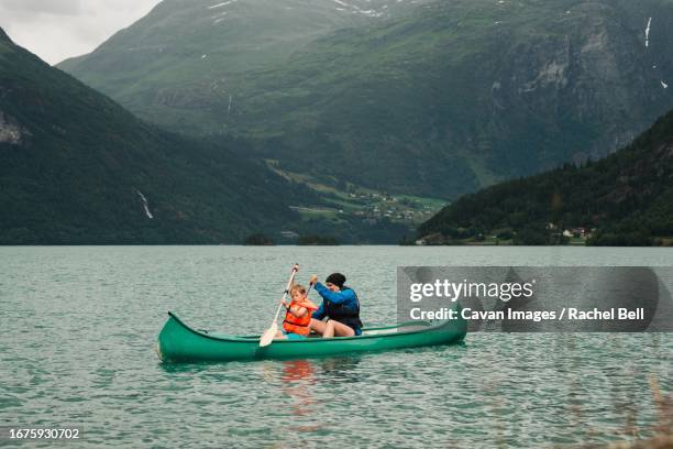 mother and son canoeing in a norwegian fjord - two people canoeing on a lake stock pictures, royalty-free photos & images