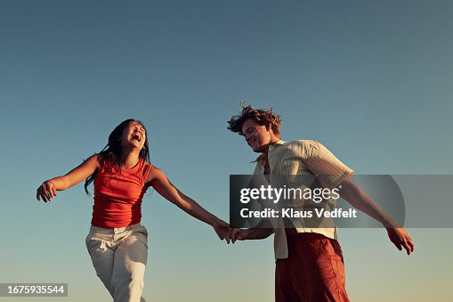 Happy friends enjoying against clear blue sky Happy friends enjoying against clear blue sky