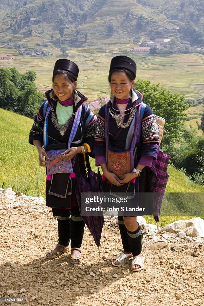 Black Hmong tribal women dress in indigo clothing, enormous...
