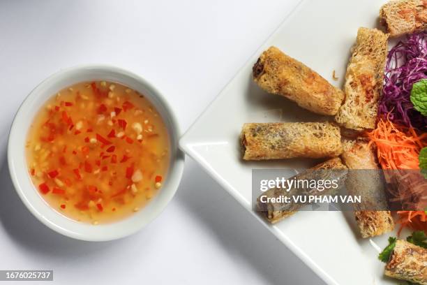 pork spring rolls - vietnamese style cuisine on white background - nuoc cham stock pictures, royalty-free photos & images