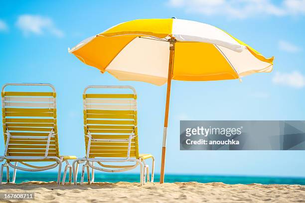 beach paradise - beach umbrella sand stockfoto's en -beelden