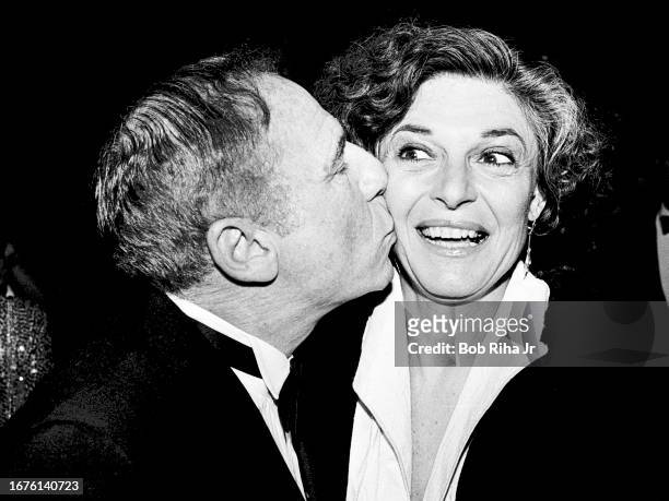 Actor Mel Brooks gives wife Actress Anne Bancroft a kiss at fundraising dinner benefit for the American Ballet Theatre, March 4, 1985 in Beverly...