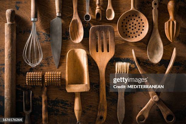 wooden cutlery and kitchenware arrangement on rustic wood table board - kitchenware shop stock pictures, royalty-free photos & images