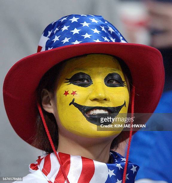 Woman dressed up to support the USA smiles ahead of the Poland-USA Group D match at the 2002 FIFA World Cup Korea/Japan in Daejeon, 14 June 2002. It...