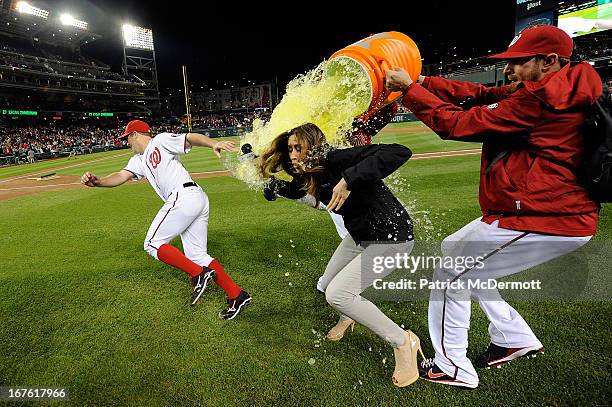 Jordan Zimmermann of the Washington Nationals and MASN's sideline reporter Julie Alexandria are dunked with gatorade by Drew Storen and Ryan Mattheus...