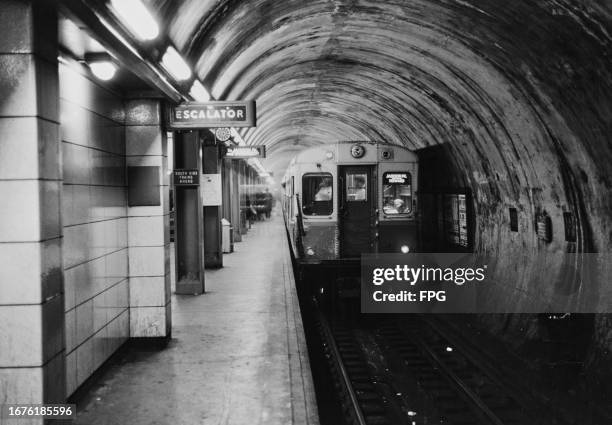 Jackson Park-Howard' train pulls into a platform of the State Street subway, an underground section of the Chicago 'L' rapid transit system in The...