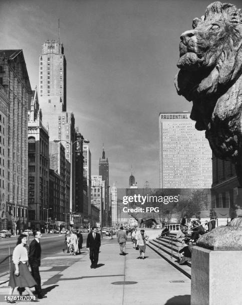 The Prudential Building rising beyond the bronze lions at the bottom of the entrance stairs to the Art Institute of Chicago in Grant Park, on South...