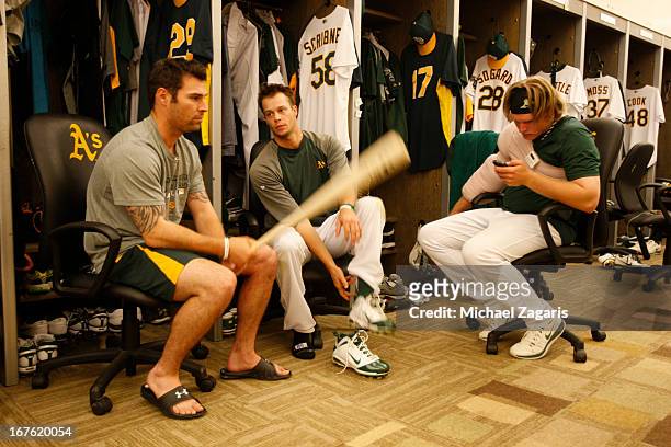 Scott Sizemore, Evan Scribner and A.J. Griffin of the Oakland Athletics relax in the clubhouse prior to the game against the Detroit Tigers at O.co...
