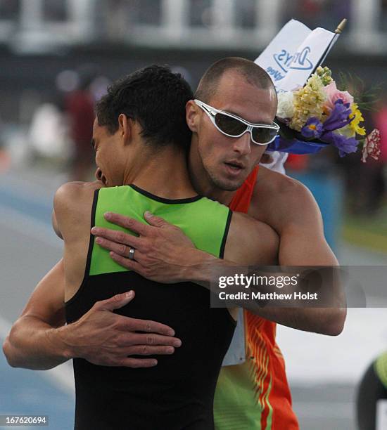 Lugelin Santos of Puma gets a hug from Jeremy Wariner of Adidas after the Men's 400 Meter London Games Rematch at the Drake Relays, on April 26, 2013...