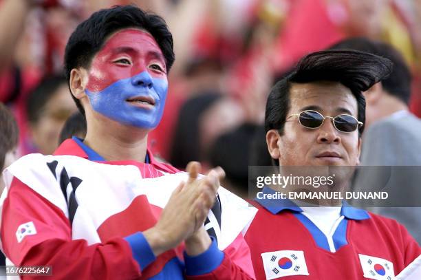 South Korean football fans cheer for their national squad 21 May 2002 during a pre-World Cup friendly match between South Korea and England at...