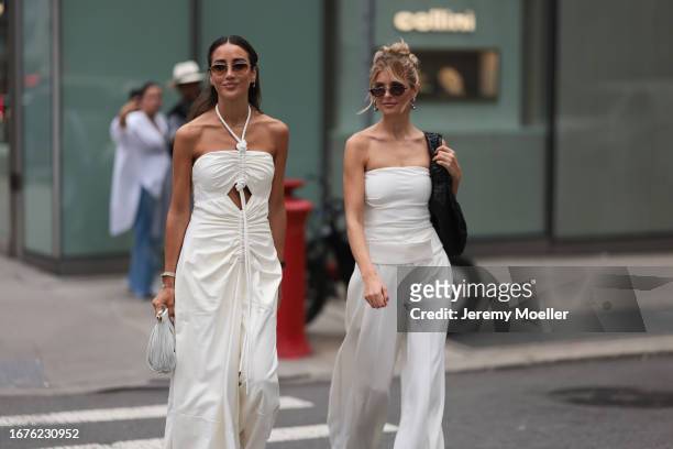 Tamara Kalinic is seen outside Proenza Schouler show wearing silver hardware round sunnies, a laced around white Proenza Schouler dress with open cut...