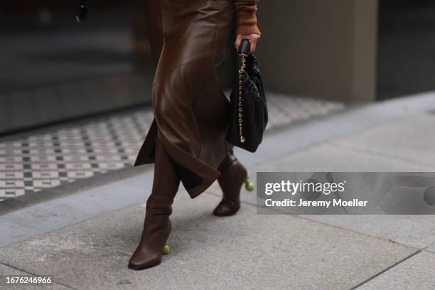 Aimee Song is seen outside Proenza Schouler show wearing golden Tiffany hardware necklace, brown wool pullover, brown leather skirt with matching...