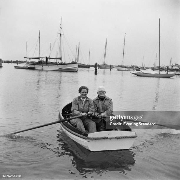 Sailors Eric Hiscock with his wife Susan Hiscock rowing a boat, April 24th, 1958.