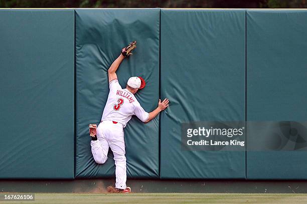 Brett Williams of the North Carolina State Wolfpack runs into the center field wall during a game against the North Carolina Tar Heels at Doak Field...