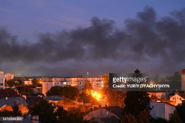 Black smoke billows over the city after drone strikes in the western Ukrainian city of Lviv on September 19 amid Russia's military invasion on...