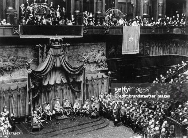 King Victor Emmanuel reads his speech from the throne at the opening of the Italian Parliament. In the picture on the right standing Prime Minister...