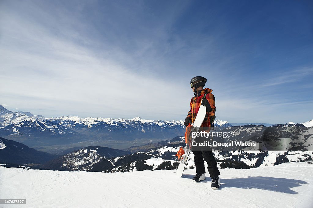 Snowboarder looking down slope in the Swiss Alps.