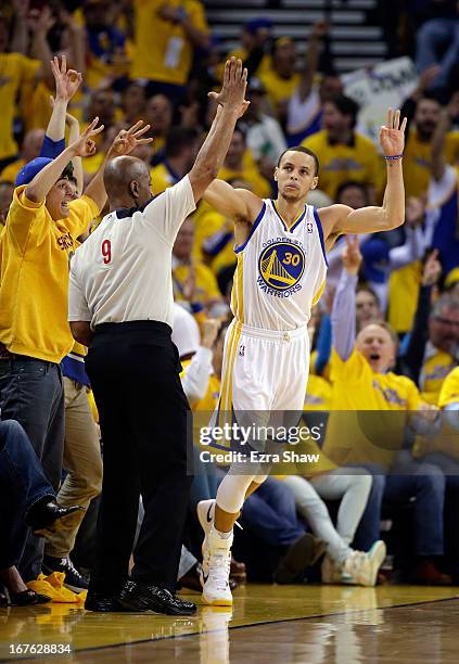 Stephen Curry of the Golden State Warriors reacts after making a three point basket against the Denver Nuggets during Game Three of the Western...