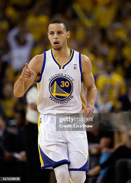 Stephen Curry of the Golden State Warriors reacts after making a three point basket against the Denver Nuggets during Game Three of the Western...