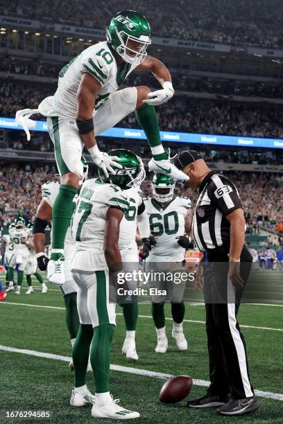 Wide receiver Allen Lazard of the New York Jets leaps over Garrett Wilson after Wilson caught a three-yard touchdown reception against the Buffalo...