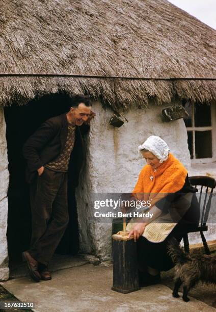 Crofters wife in the Highlands churns butter using the traditional method , 1956. Original Publication : Picture Post - 8602 - unpub.