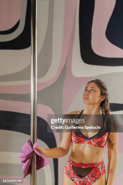 pole dancer cleaning her pole after her training session - pole dancing class stock pictures, royalty-free photos & images