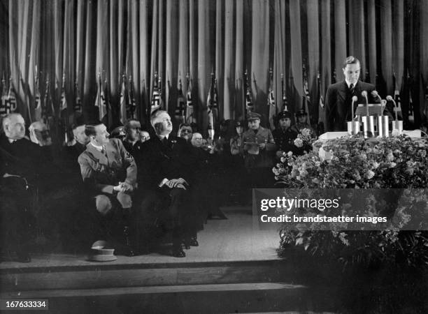 Adolf Hitler at the opening of the international automobil exhibition. Messegelände Kaiserdamm/Berlin. At the pult: racer Manfred von Brauchitsch....