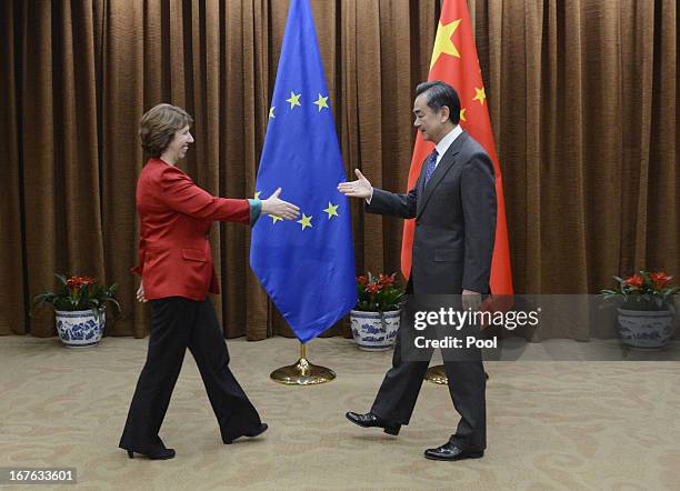 European Union Foreign Policy Chief Catherine Ashton shakes hands with Chinese Foreign Minister Wang Yi before their meeting at the Chinese Foreign...