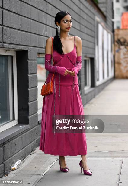 Malvika Sheth is seen wearing a Studio Moon Ray pink outfit, Gucci shoes, Paco Rabanne bag, Emma Pills earrings seen during NYFW S/S 2024 on...