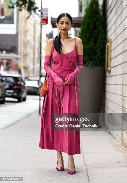 Malvika Sheth is seen wearing a Studio Moon Ray pink outfit, Gucci shoes, Paco Rabanne bag, Emma Pills earrings seen during NYFW S/S 2024 on...
