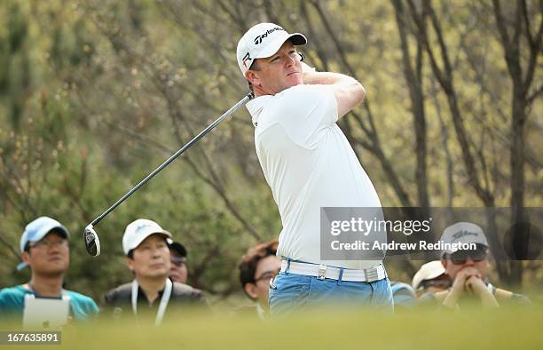 Marcus Fraser of Australia hits his tee-shot on the sixth hole during the third round of the Ballantine's Championship at Blackstone Golf Club on...