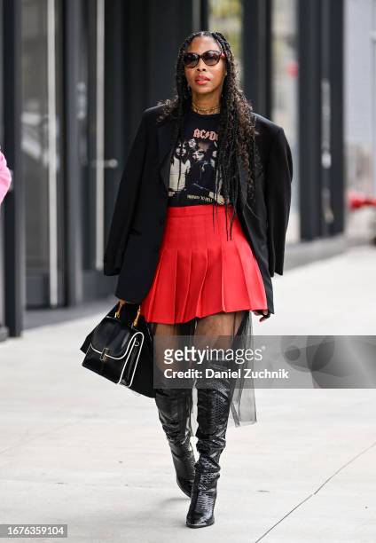 Guest is seen wearing a black blazer, black vintage t-shirt, red skirt , tule skirt and balck boots during NYFW S/S 2024 on September 11, 2023 in New...