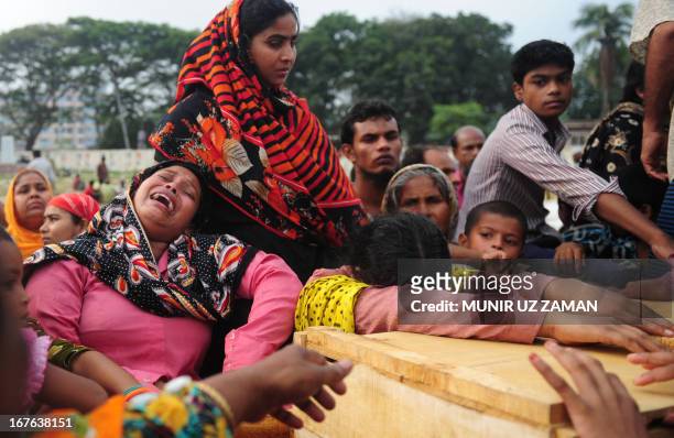 Bangladeshi relatives of Mohammad Abdullah react after looking into the coffin three days after the Rana Plaza garment building collapsed in Savar,...