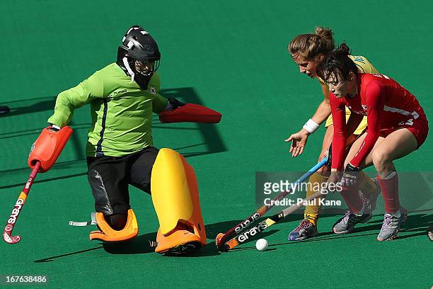 Ashleigh Nelson of Australia is challenged by goal keeper Lee Sin Hye and Lee Young Sil of Korea during the International Test match between the...