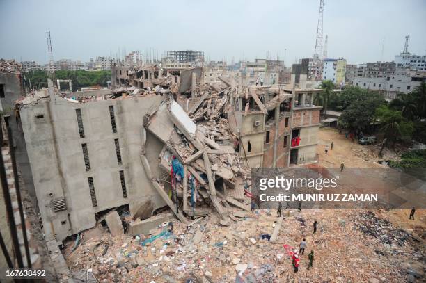 Bangladeshi volunteers and rescue workers search for survivors under rubble three days after the Rana Plaza garment building collapsed in Savar, on...
