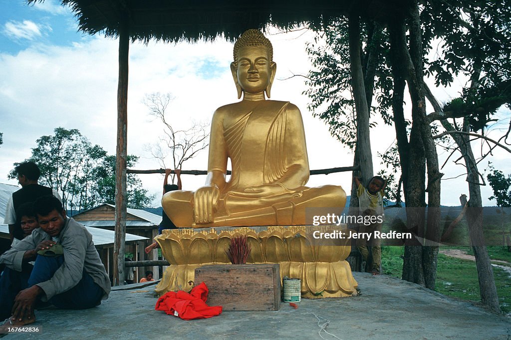 A concrete and gold painted Buddha statue donated to Veal...